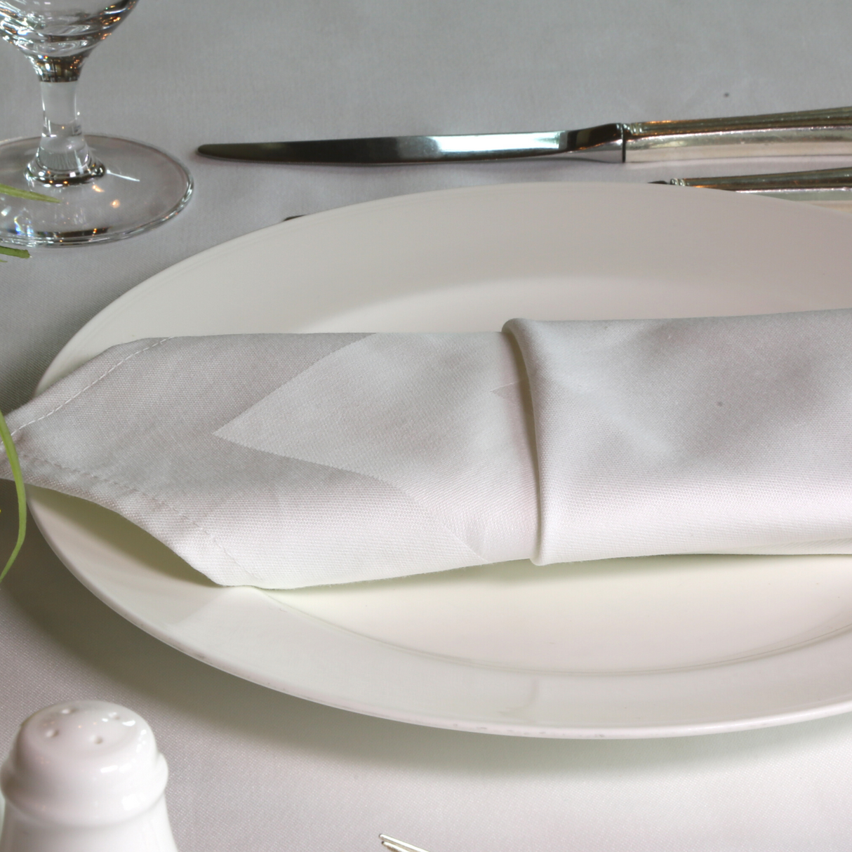 White satin band napkin placed on the dressed up table of the restaurant.